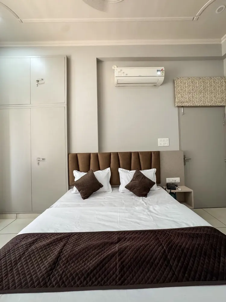 Bedroom with queen bed, wardrobe and air conditioner