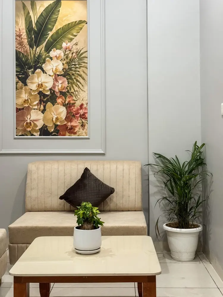 Sofa seating with indoor plants and floral art